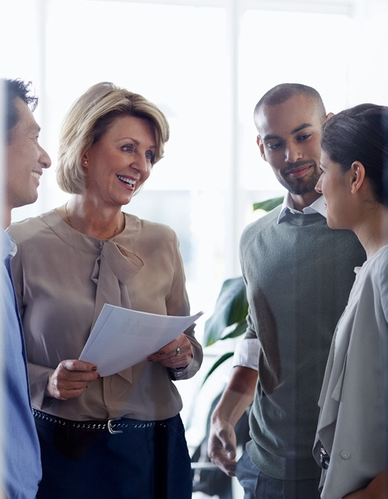 woman talking to a group of people in an office