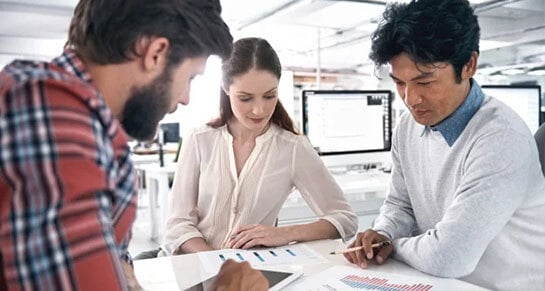 three people concentrated in a business meeting