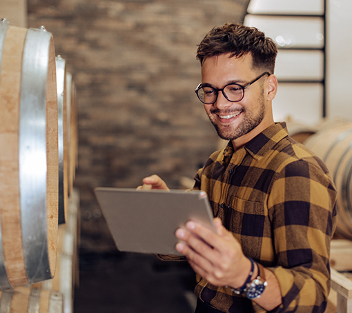 Entrepreneur smiling, working on his tablet