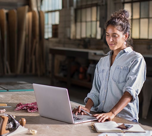 entrepreneur in her studio, working on her computer