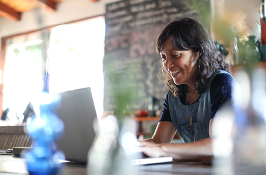 woman smiling working on her computer