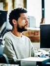 man looking serious working on his computer