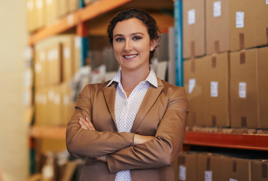 Proud woman entrepreneur, arms crossed in a back store