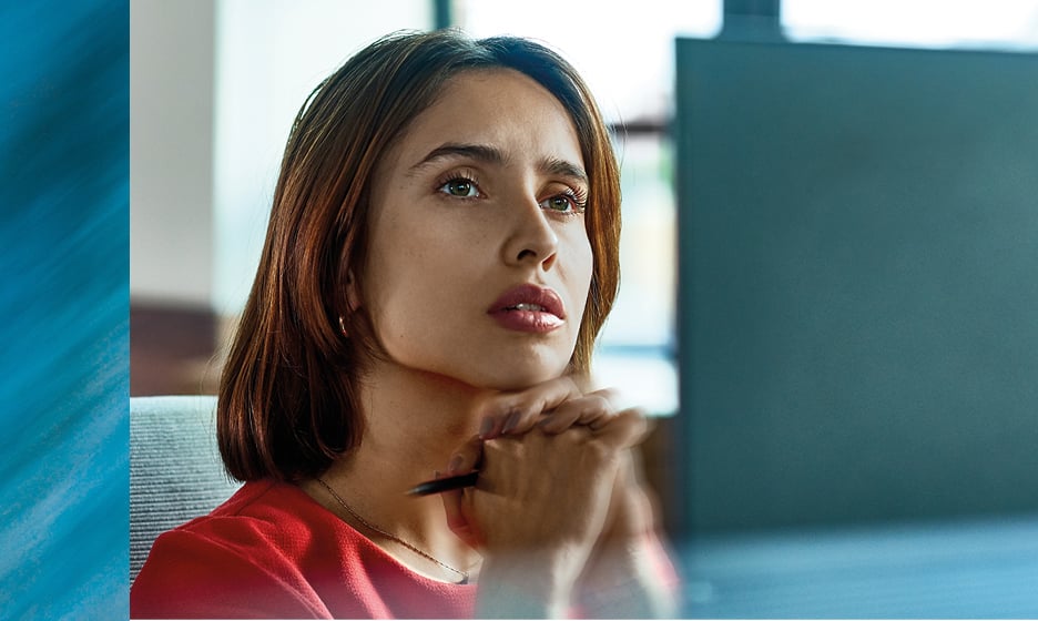 Woman in front of her computer thinking about her digital future