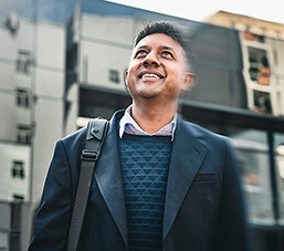 Entrepreneur looking up with commercial buildings in background