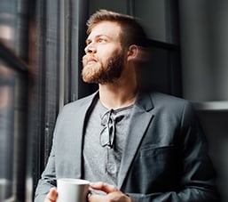 businessman looking out of window