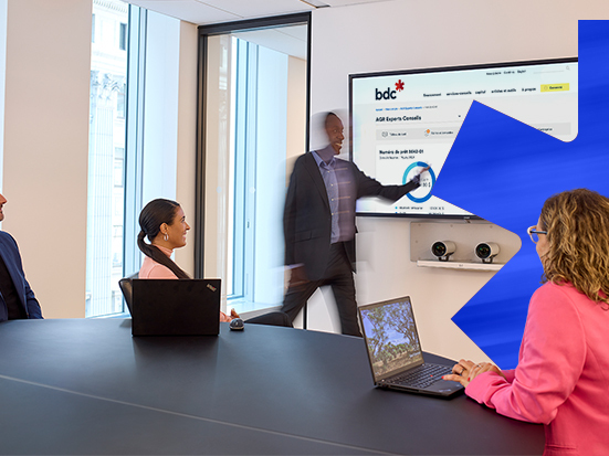 Man presenting a chart to his team with a blue leaf in the background