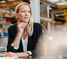 Thinking woman entrepreneur in factory