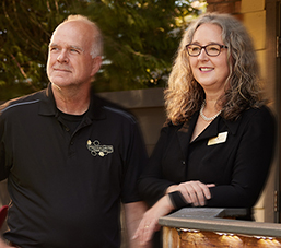 Bill and Teresa Townsley in front of Festina Lente Estate Winery building