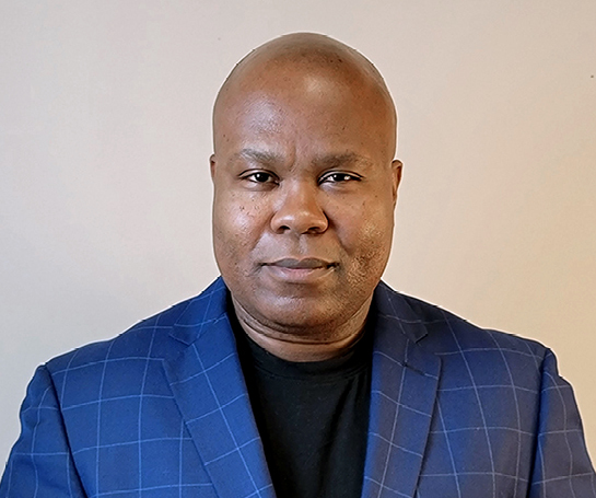 Black bald men wearing a blue plaid jacket on grey background