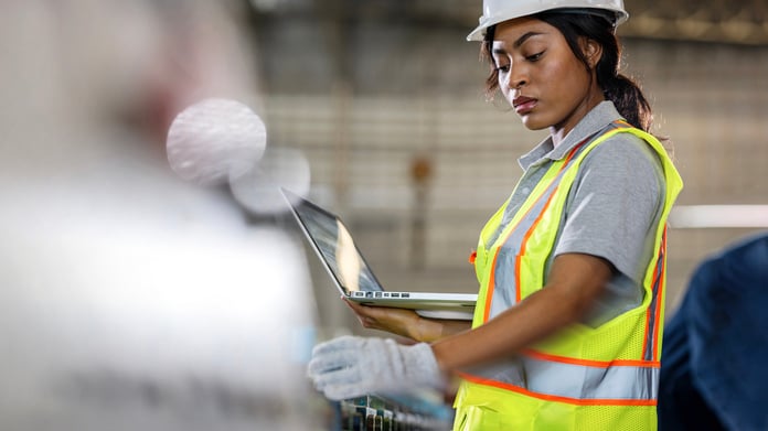 Woman calibrating machinery