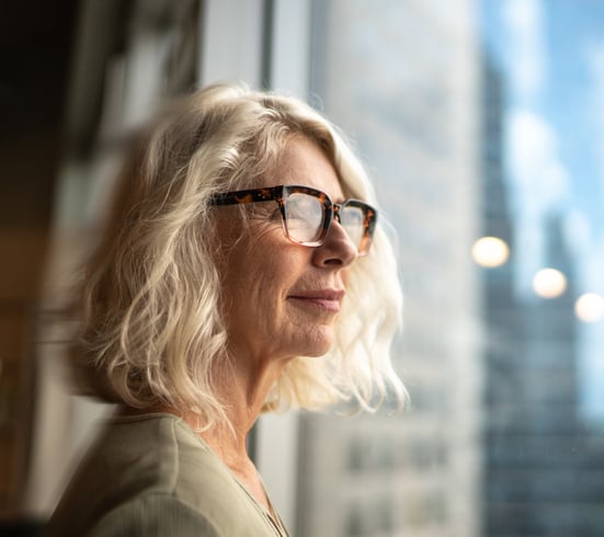 Mature woman looking out the window