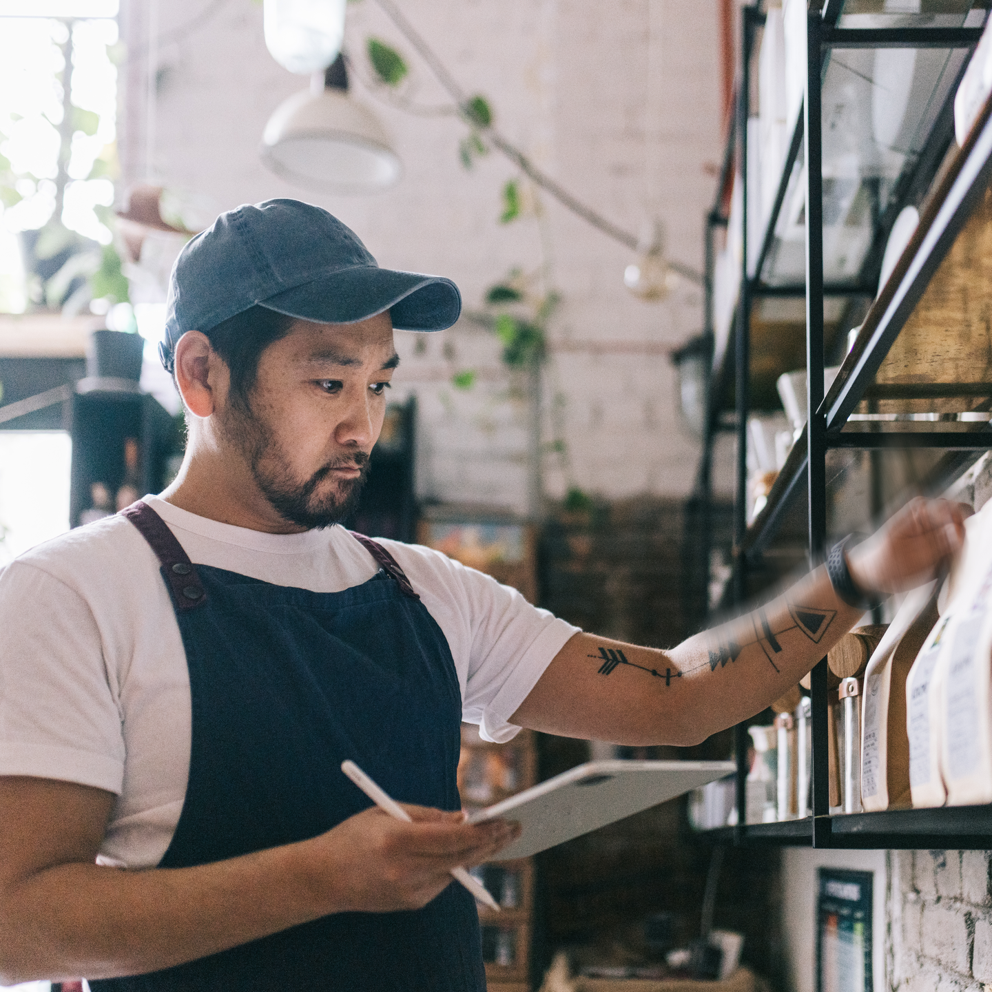 Coffee shop owner looking at his inventory