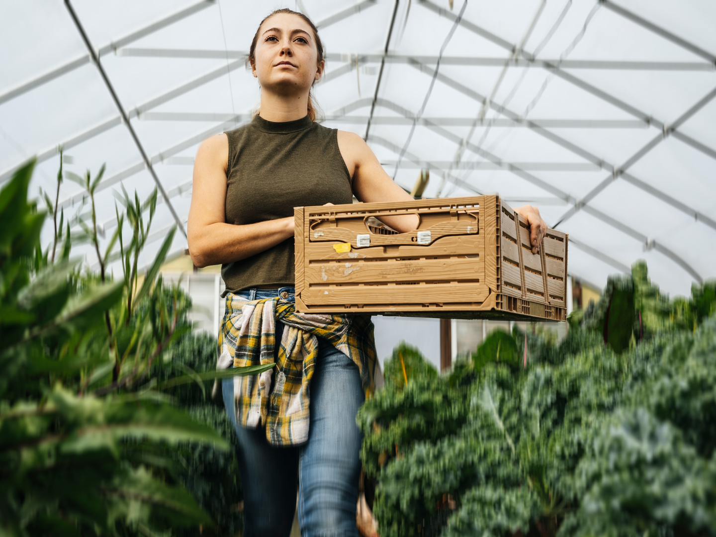 woman walking though greenhouse