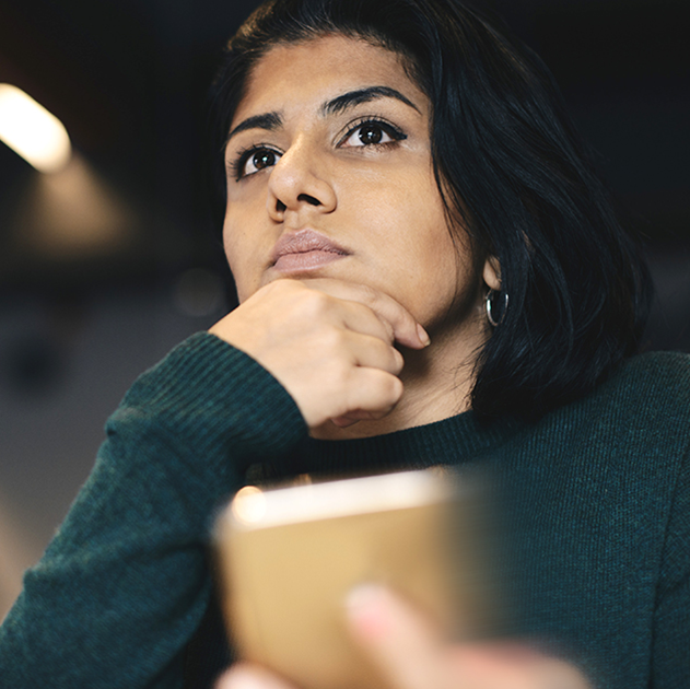 Woman lost in thoughts in front of laptop late at night