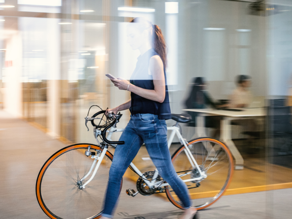 businesswoman taking her bike to her workplace