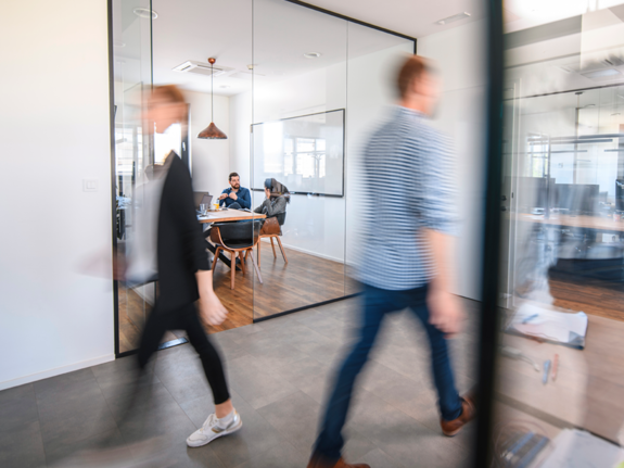 people walking in an office