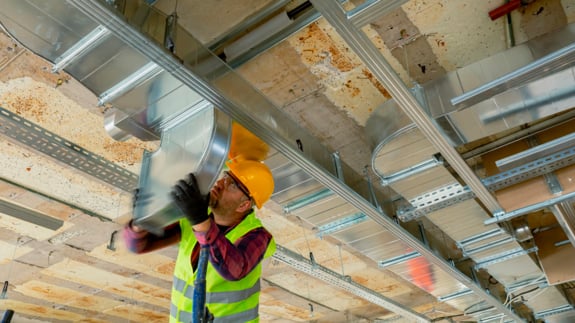 construction worker updating HVAC system