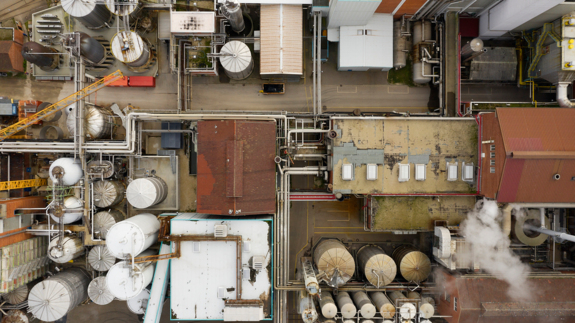 Industrial plant, paper mill, with smoking chimneys viewed directly from above.