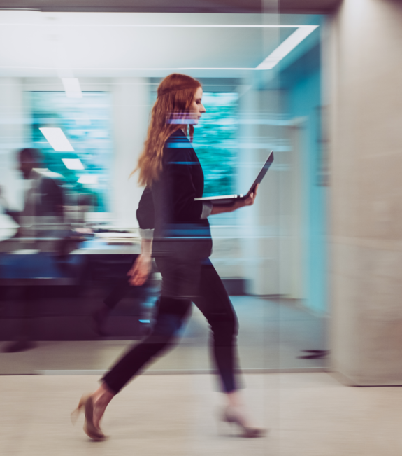 person walking with a laptop