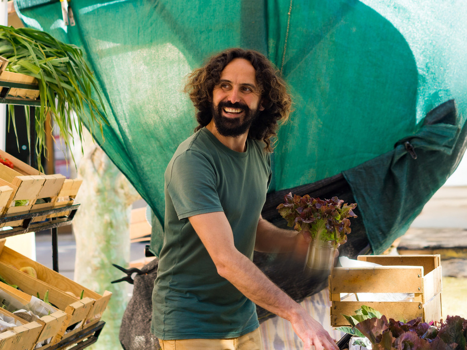 Man handling vegetable at a public market