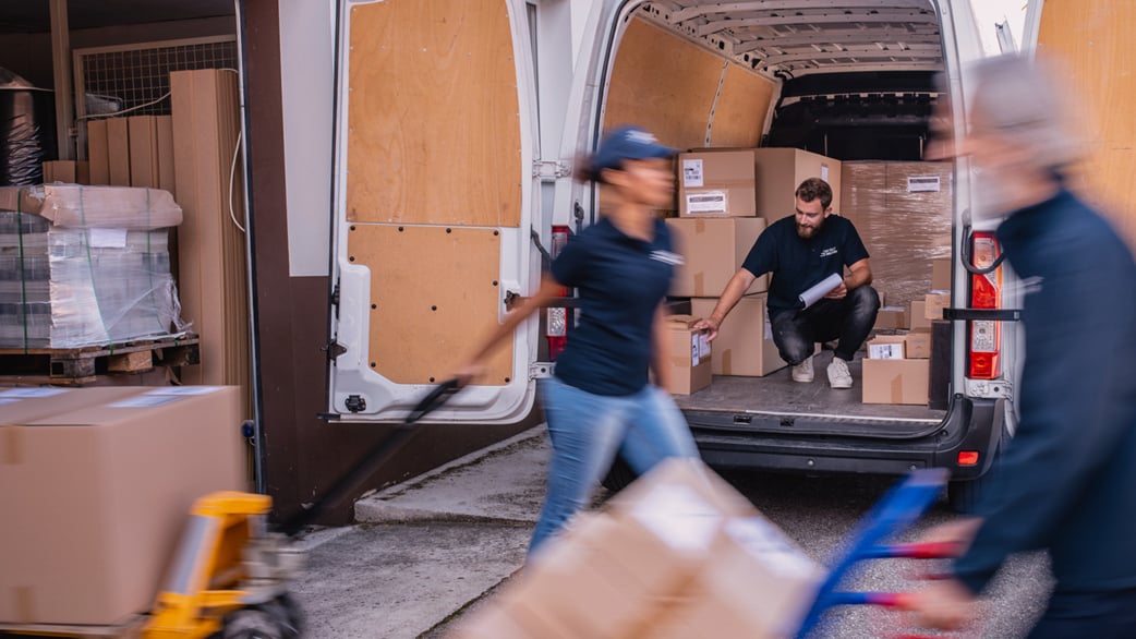 employees loading boxes onto a loading truck